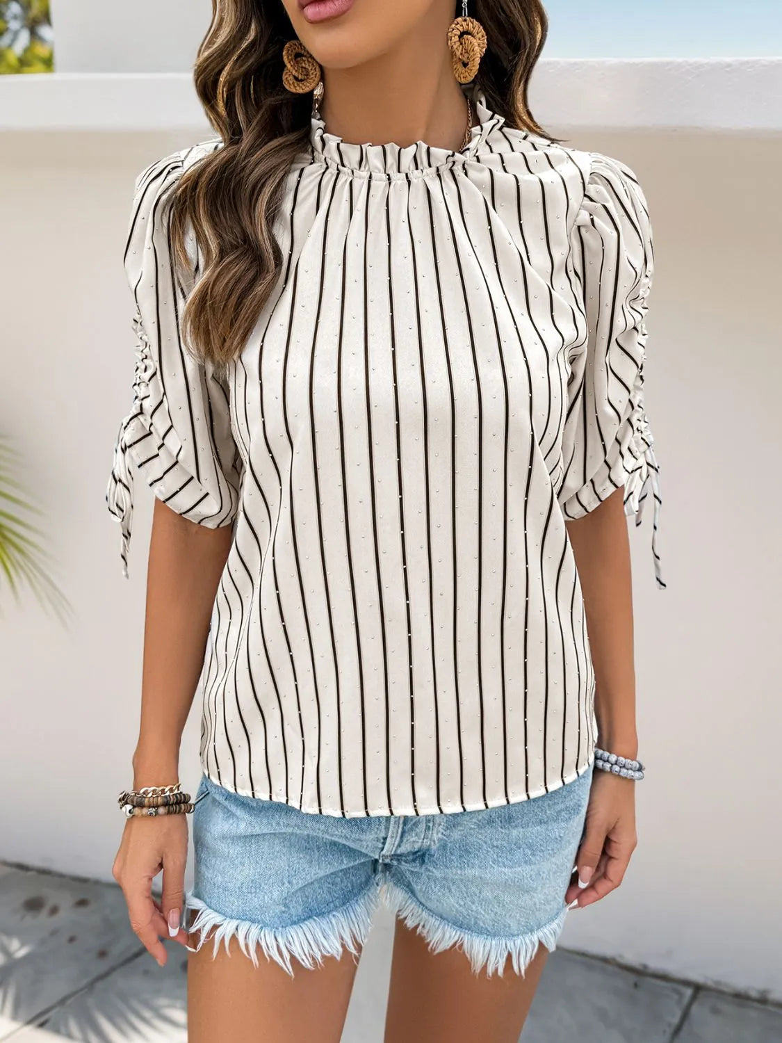 Women's Striped Half Sleeve Blouse laid flat on a table with accessories