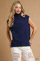 Women's Ribbed Sleeveless Turtleneck Top worn by a woman with Navy layering.