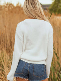 Women's Embroidered Bow Boots Drop Shoulder Sweater in cream, laid flat showing the detailed boot and bow design on the front.