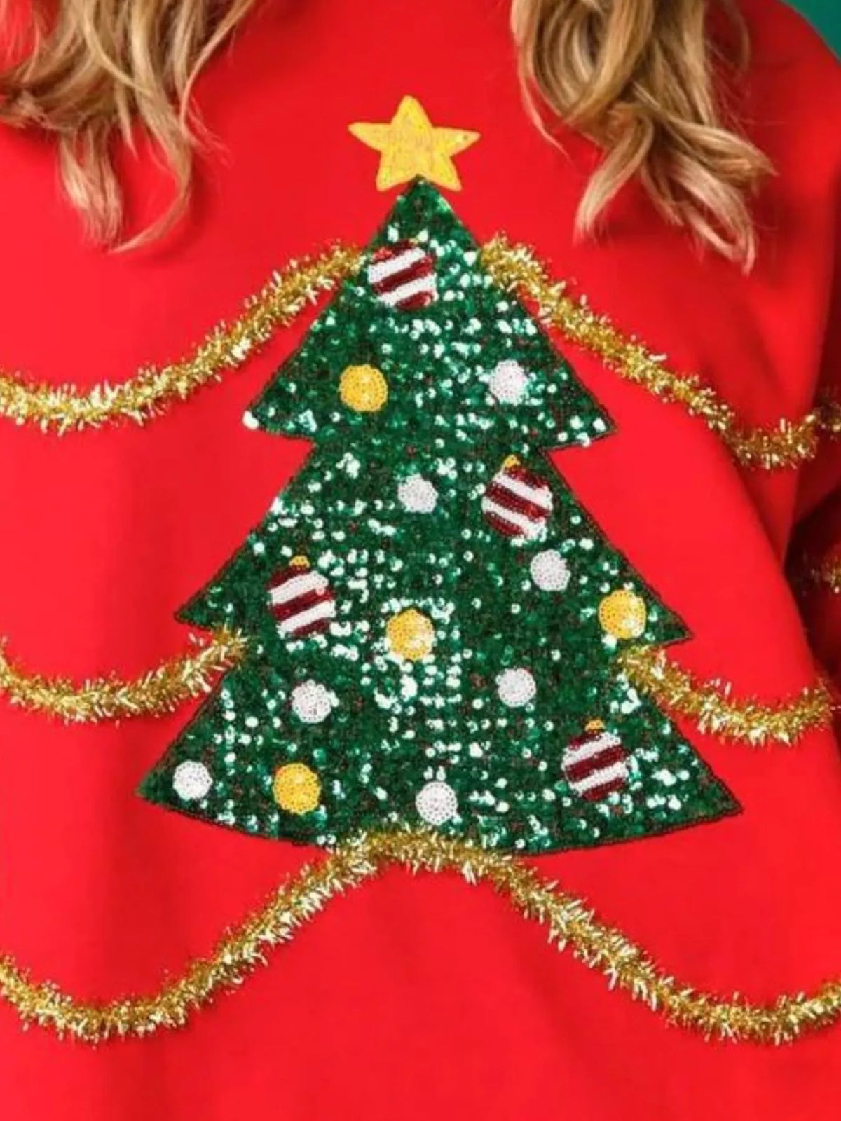 Sparkle Christmas Tree Sweatshirt on a model against a festive background.