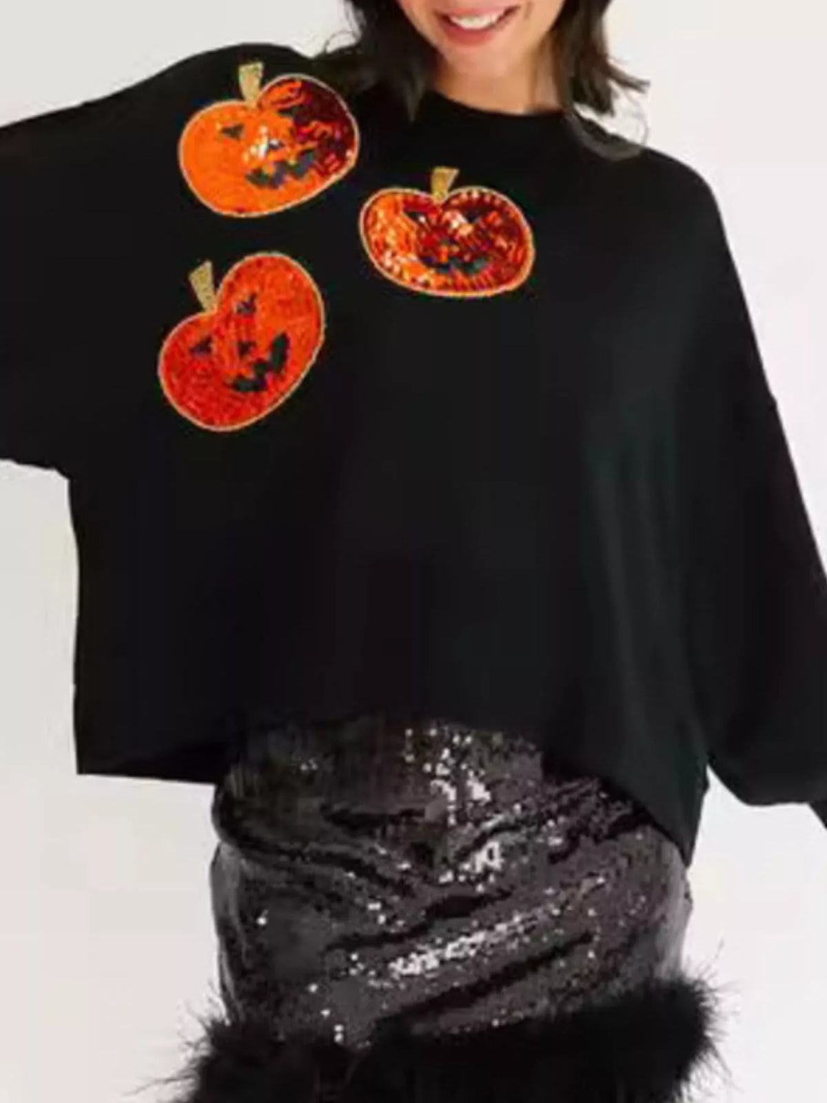 Spooky Pumpkin Sequin Sweatshirt reversible from pumpkin to moon and bats design on a model