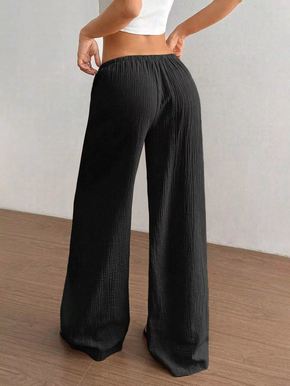 Women's plus size cotton drawstring wide leg pants in Black, showing relaxed fit and tie waist.
