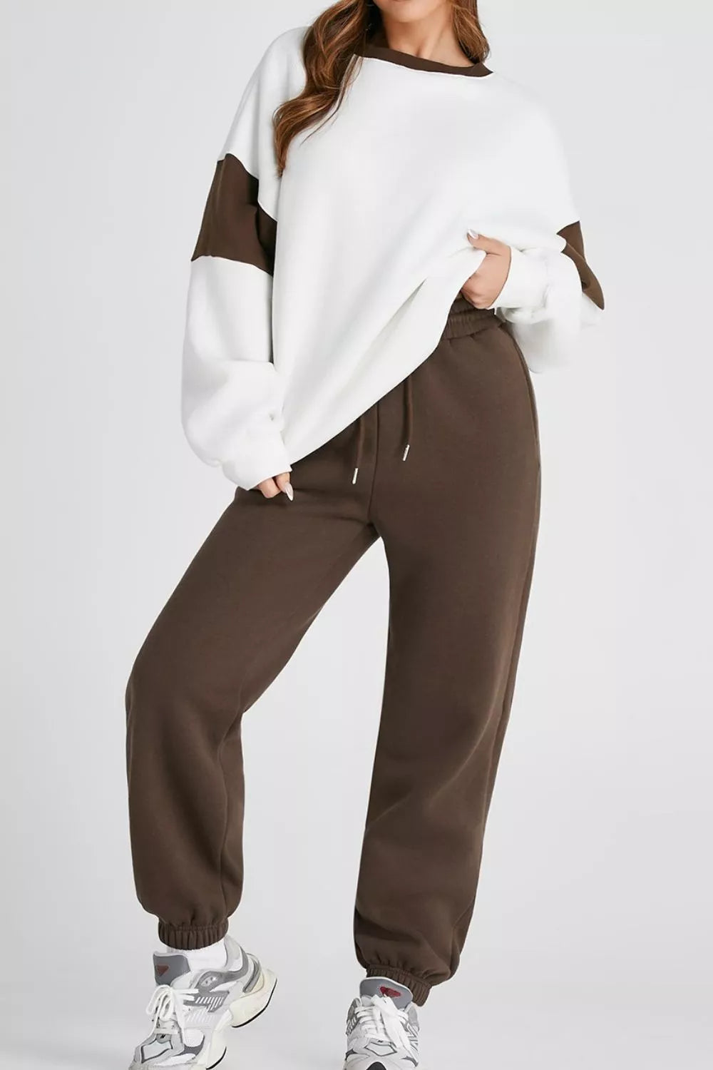 Women's Oversized Loungewear Set in White, featuring a drop-shoulder sweatshirt and matching joggers on a model.