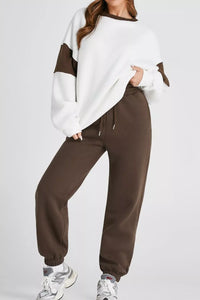 Women's Oversized Loungewear Set in White, featuring a drop-shoulder sweatshirt and matching joggers on a model.