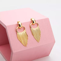18K Gold Plated Fringe Chain Earrings dangling from a model's ear, showcasing the elegant gold finish and dynamic movement.