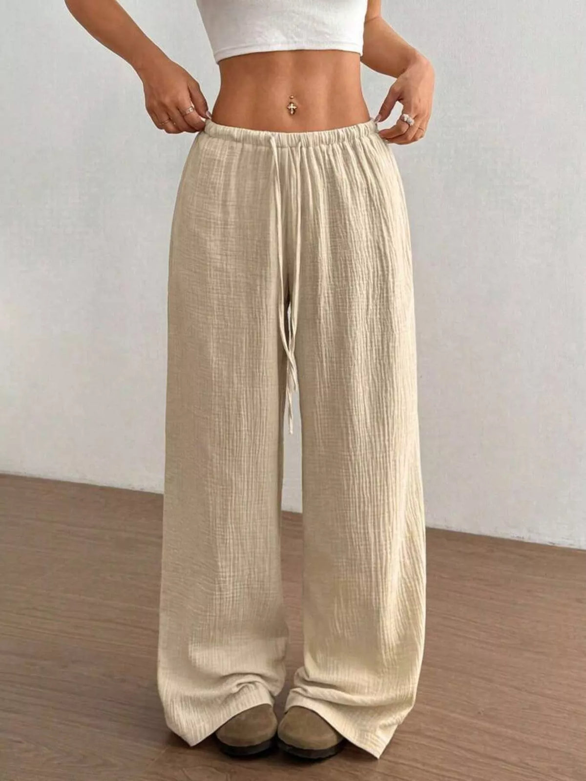 Women's plus size cotton drawstring wide leg pants, showing relaxed fit and tie waist.