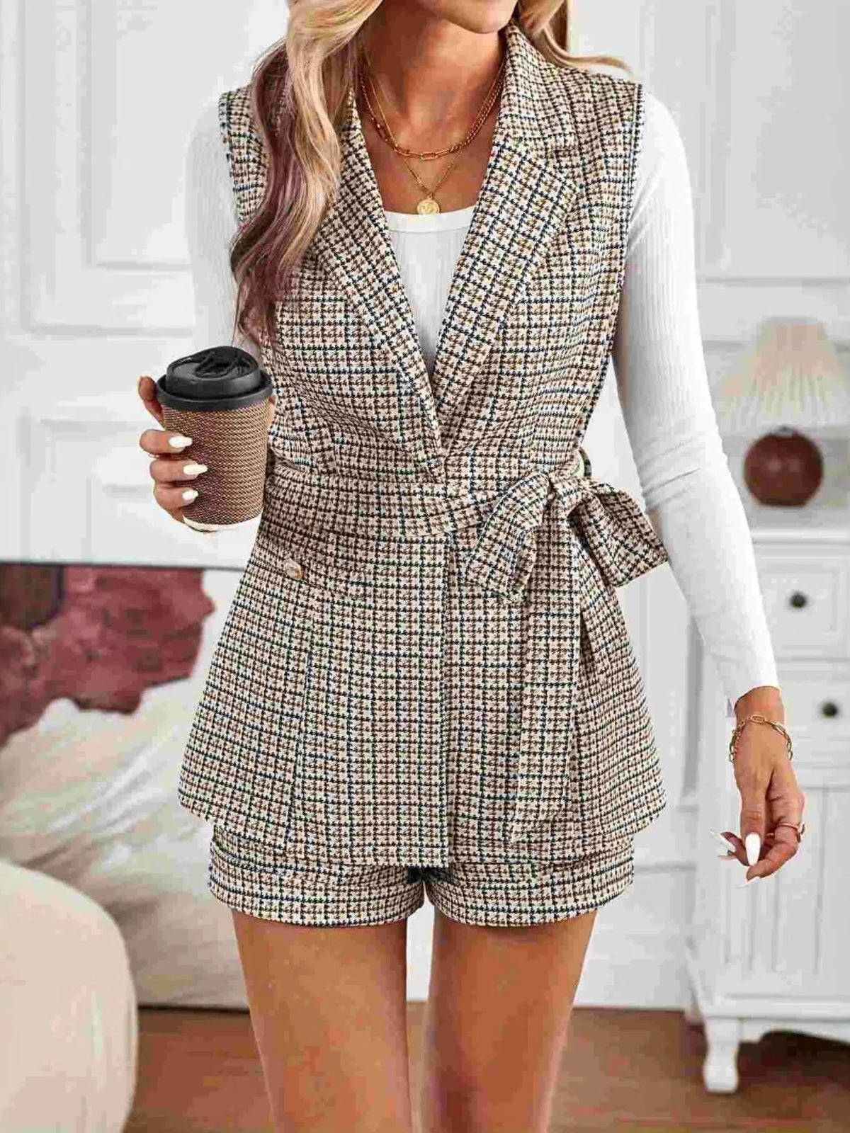 Model wearing belted houndstooth blazer vest and shorts set