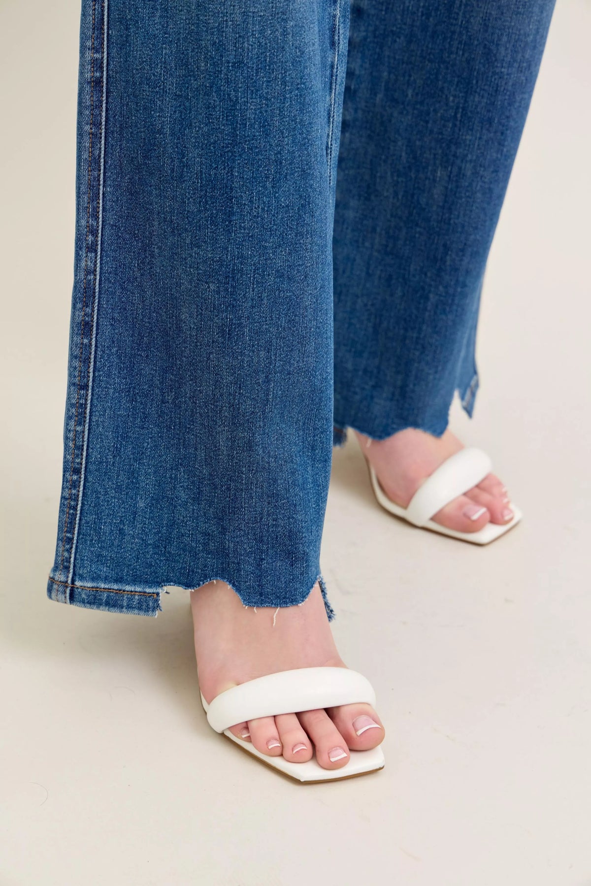 High Waist Tummy Control Jeans with Destroyed Hem on a plus-size model.