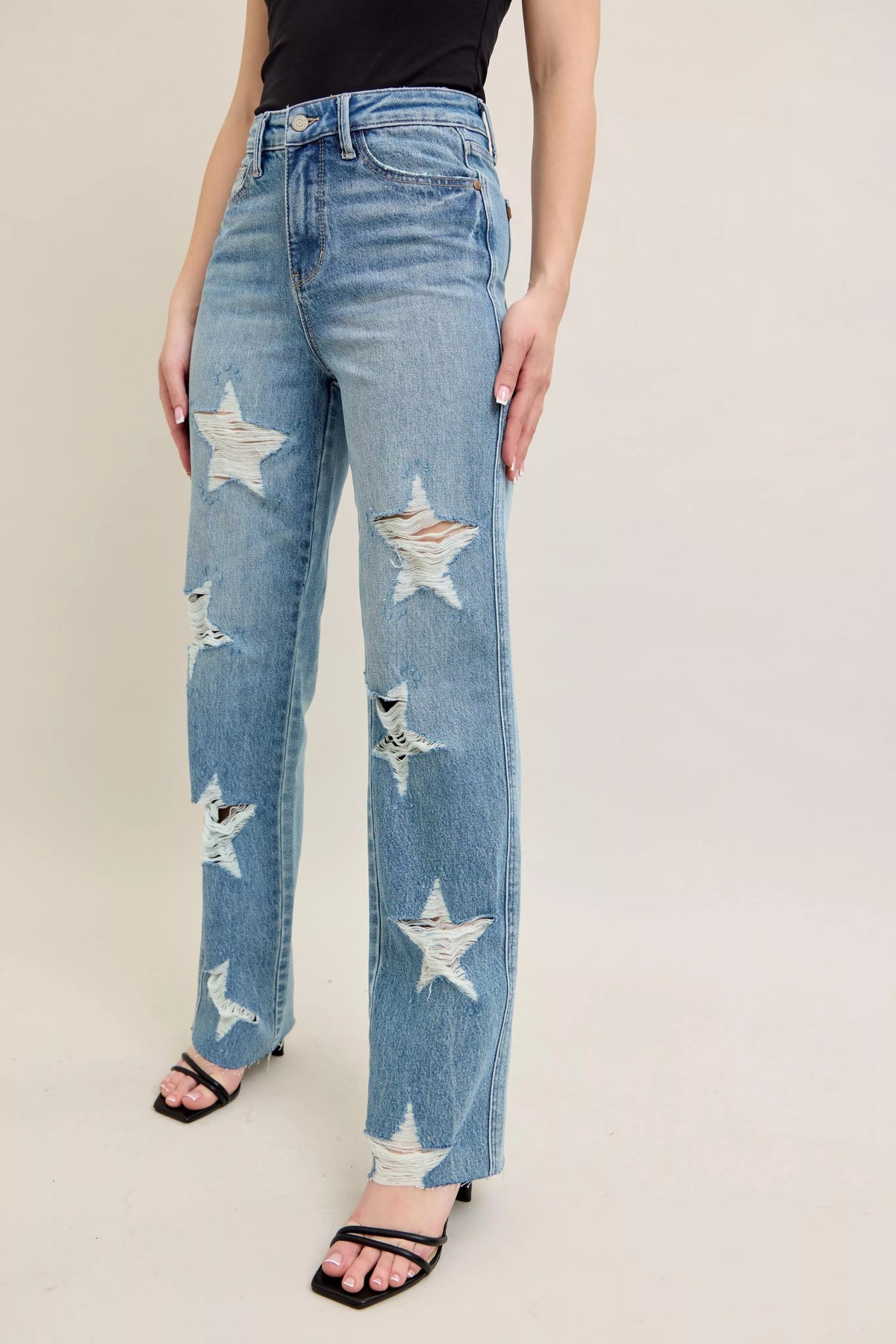 Judy Blue 90s Straight Jeans in a distressed wash, modeled from the front, showing the high waist and straight leg fit.