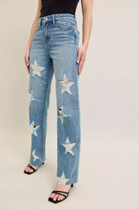 Judy Blue 90s Straight Jeans in a distressed wash, modeled from the front, showing the high waist and straight leg fit.