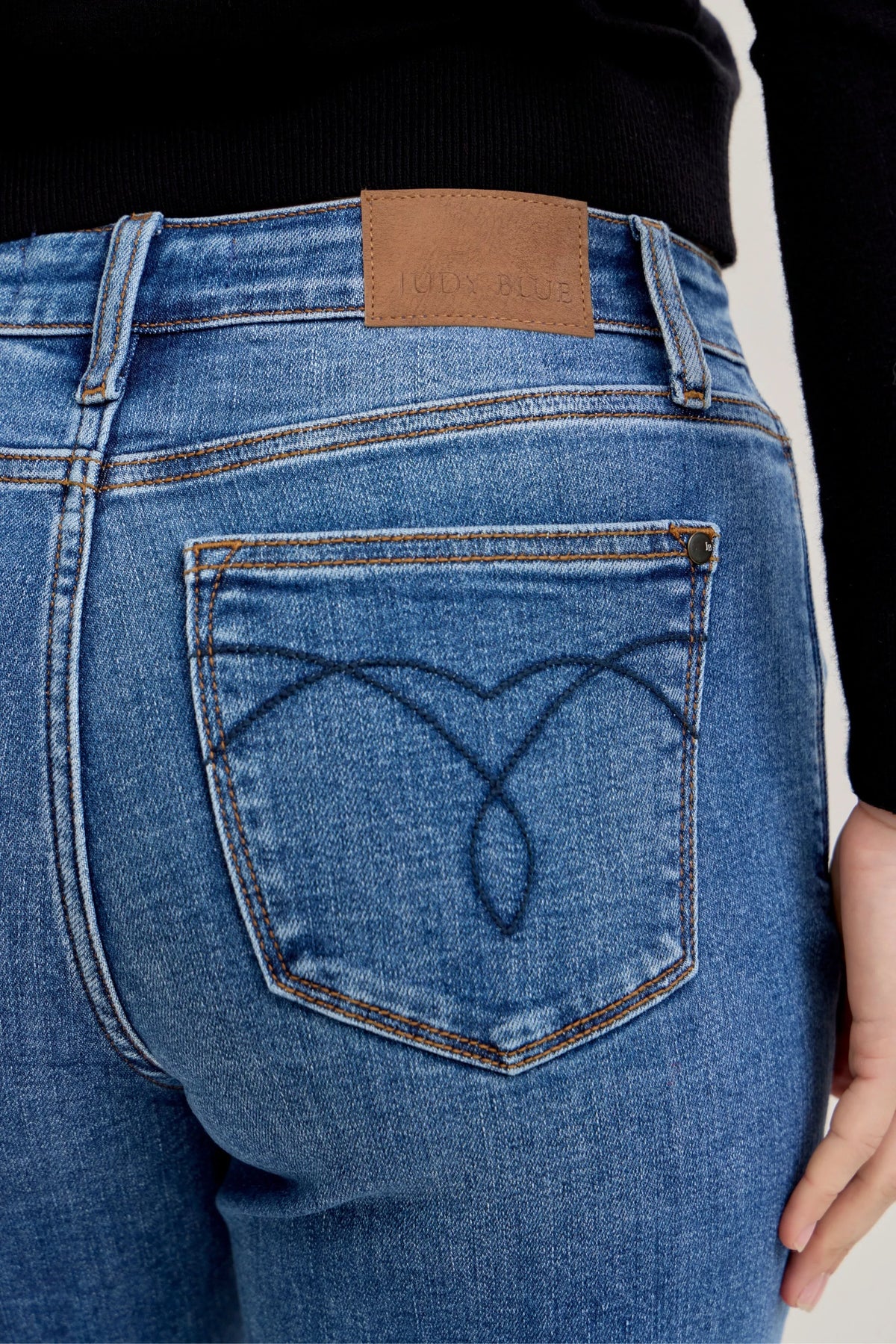 Plus Size Judy Blue Cuffed Jeans in a mid-rise, classic fit shown on a model.