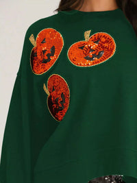 Spooky Pumpkin Sequin Sweatshirt reversible from pumpkin to moon and bats design on a model