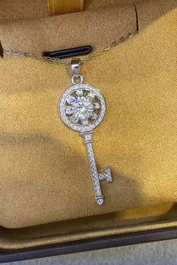 Moissanite key pendant necklace featuring a 1 Carat sparkling Moissanite stone in a platinum plated key design.