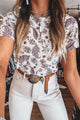 Women's ribbed mock neck long sleeve t-shirt in beige, styled with jeans.