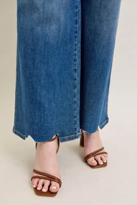 High Waist Tummy Control Jeans with Destroyed Hem on a plus-size model.