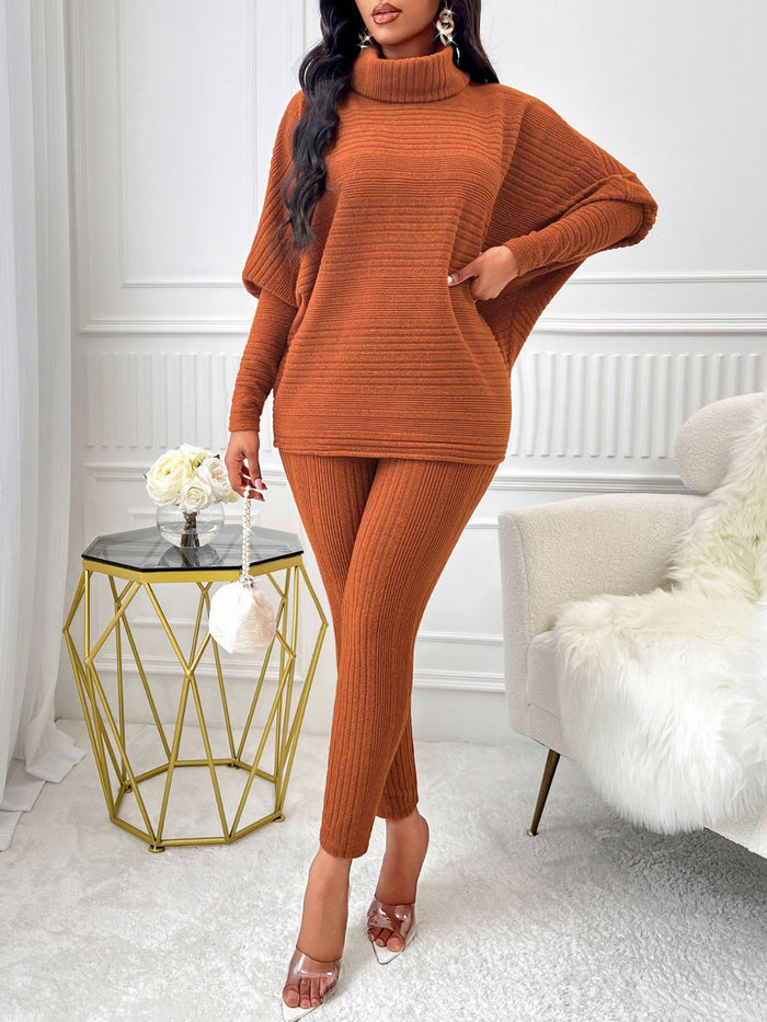 A stylish turtleneck batwing sleeve top paired with matching high-waisted pants, showcasing a modern and elegant outfit. The top features loose, flowing batwing sleeves and a fitted turtleneck design, while the pants are tailored with a sleek, straight-leg silhouette. Perfect for a chic, contemporary look.