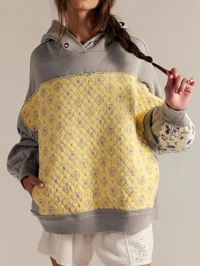 Women's Dropped Shoulder Hoodie in gray, showing the front pocket and oversized fit on a model.