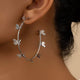 Butterfly Vine Hoop Earrings in 18K gold-plated metal, shown on a woman's ear.