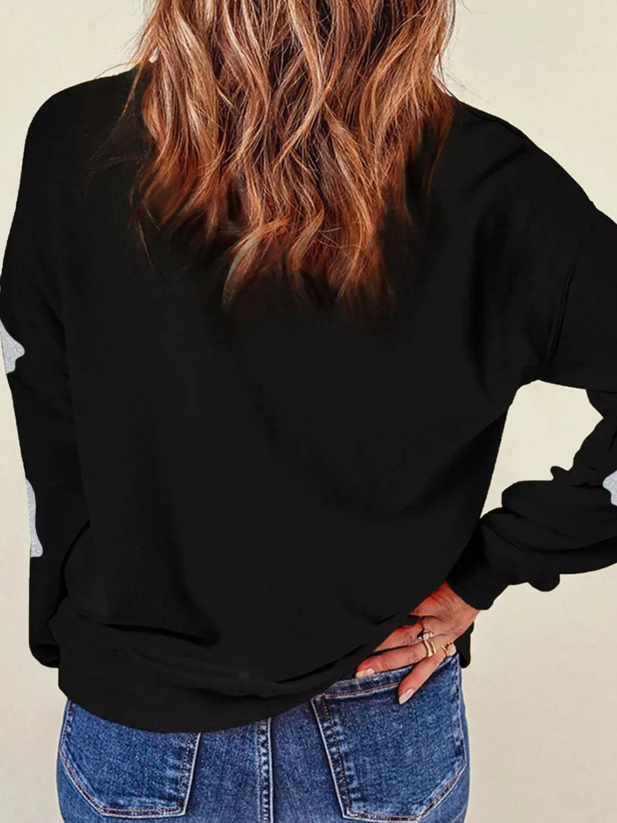 Spooky Halloween Sequin Sweatshirt showing the reversible design from black with orange sequins to orange with black sequins.