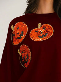 Spooky Pumpkin Sequin Sweatshirt reversible from pumpkin to moon and bats design on a model