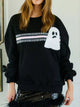 Spooky Halloween Sequin Sweatshirt showing the reversible design from black with orange sequins to orange with black sequins.