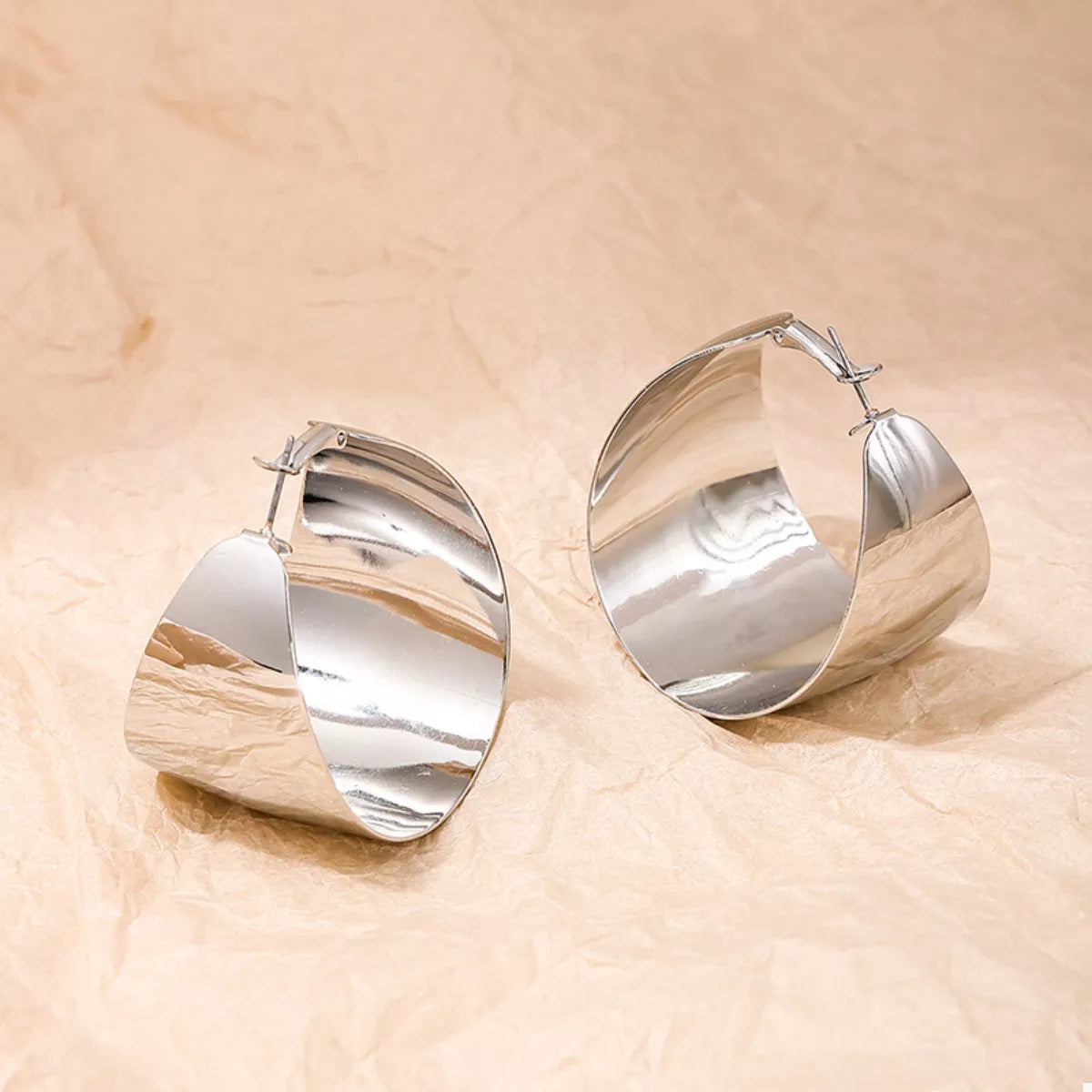 Wide Gold Hoop Earrings for Women displayed on a model.
