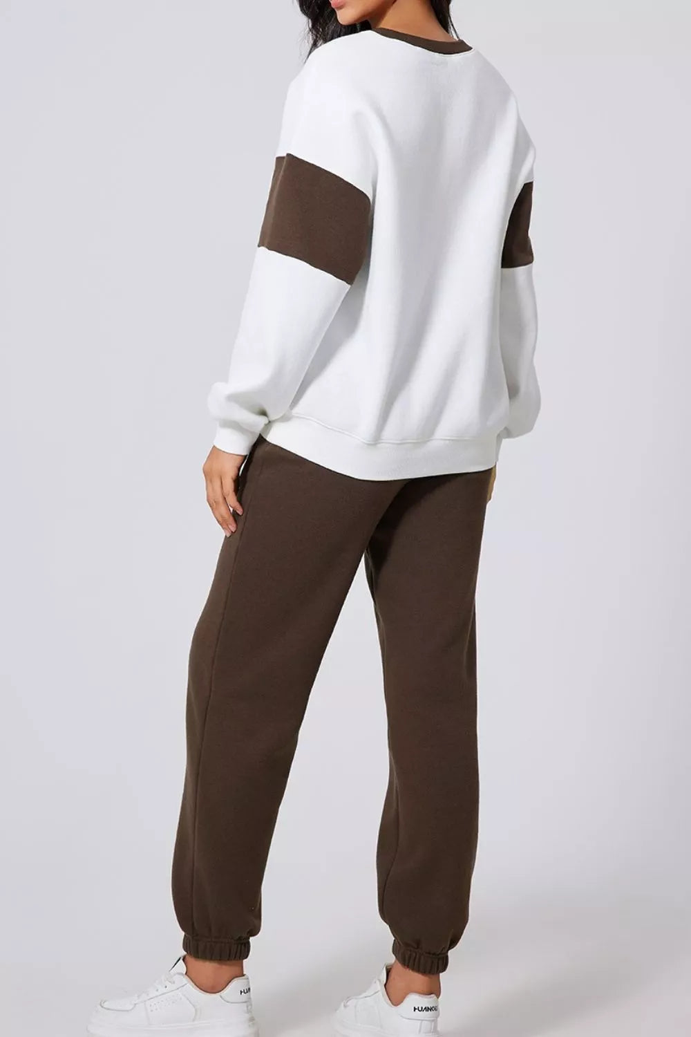 Women's Oversized Loungewear Set in White, featuring a drop-shoulder sweatshirt and matching joggers on a model.