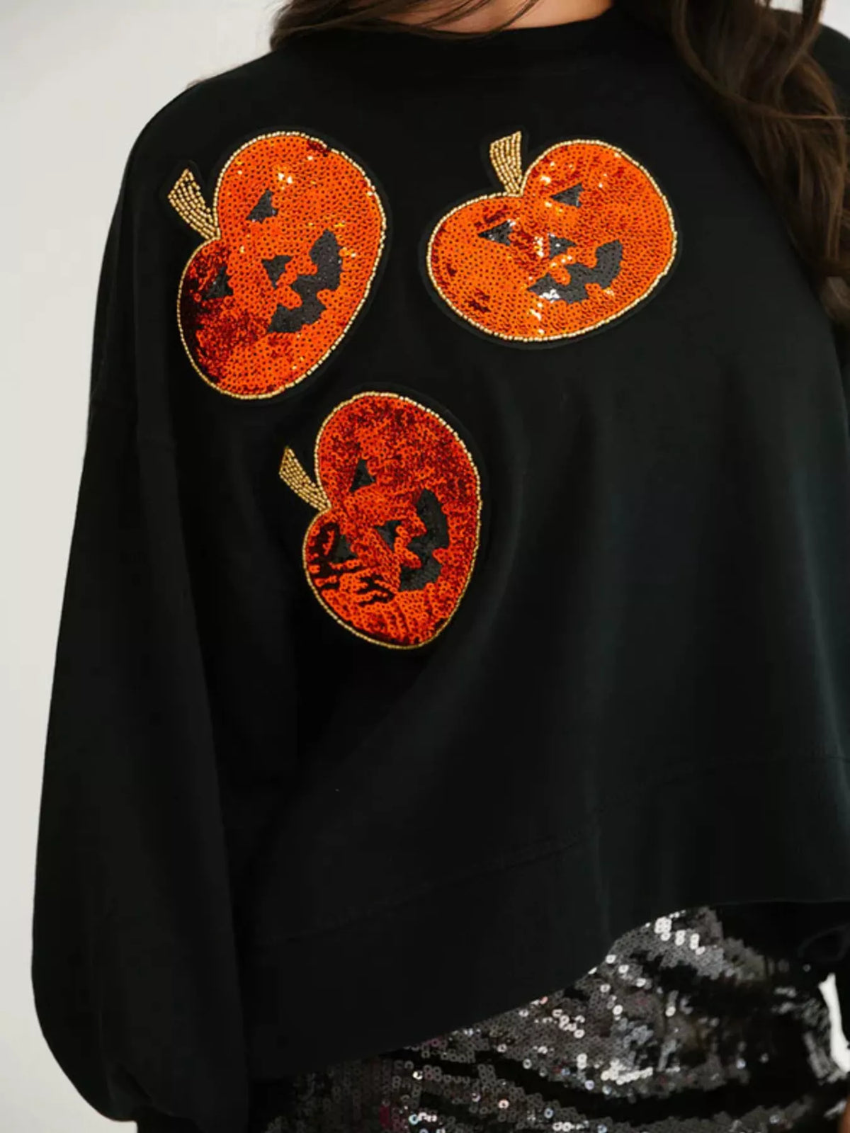 Spooky Pumpkin Sequin Sweatshirt reversible from pumpkin to moon and bats design on a model