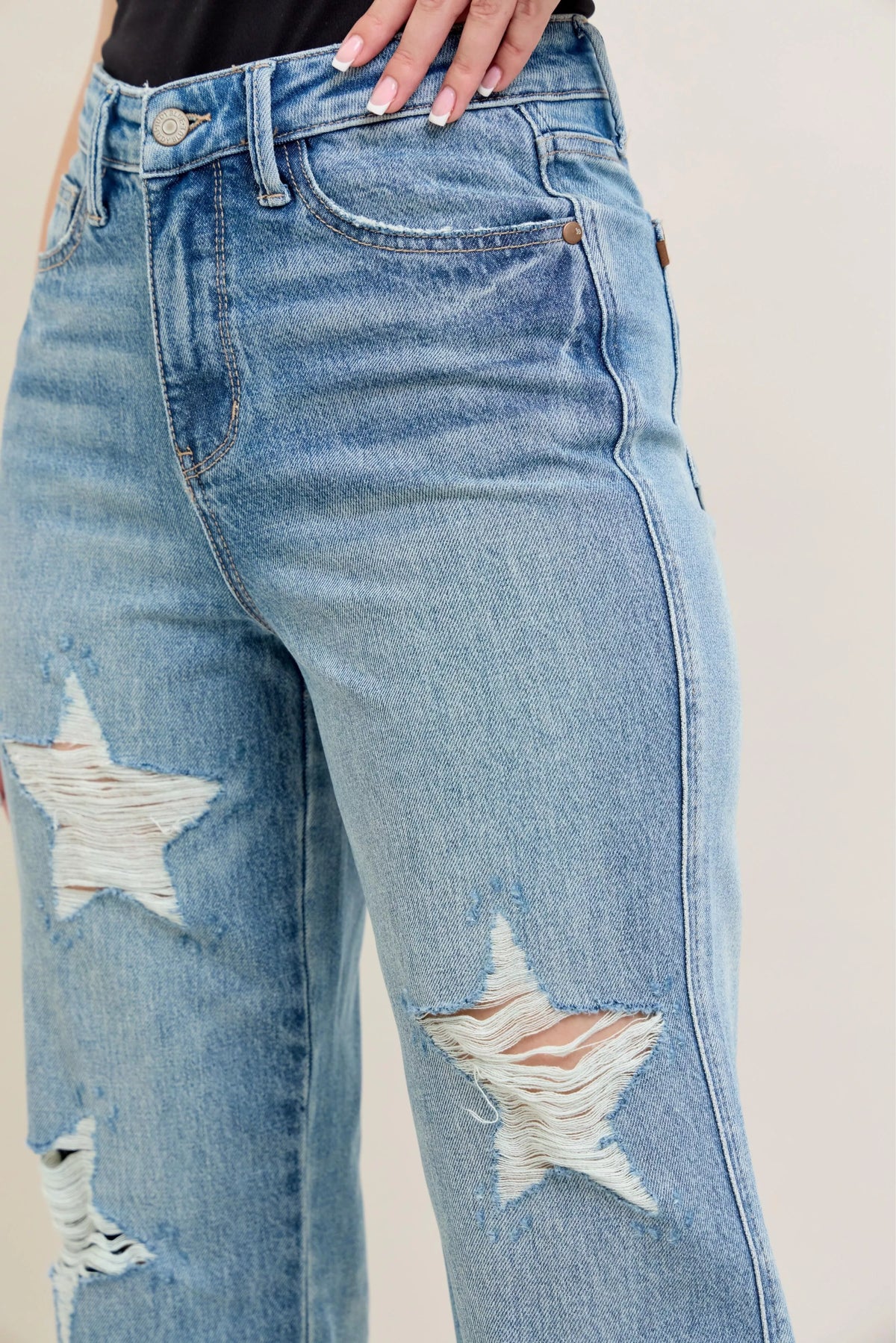 Judy Blue 90s Straight Jeans in a distressed wash, modeled from the front, showing the high waist and straight leg fit.