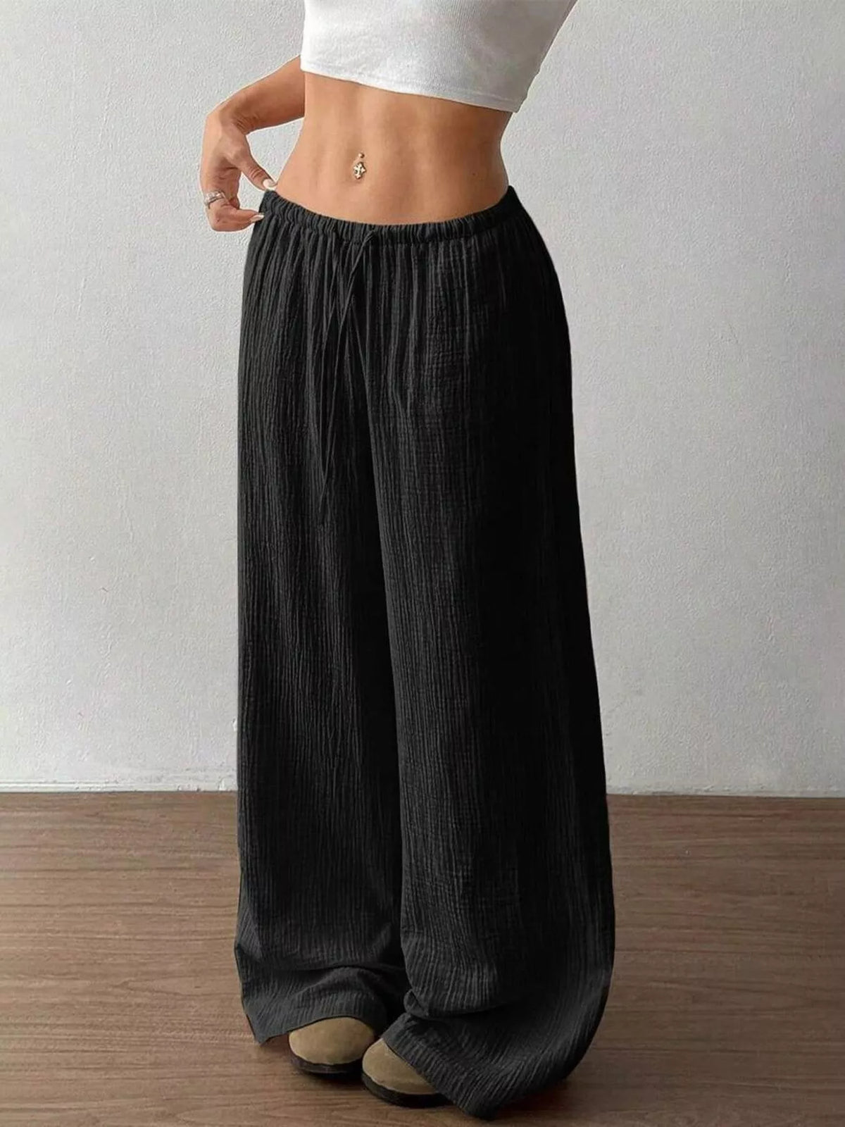 Women's plus size cotton drawstring wide leg pants in Black, showing relaxed fit and tie waist.