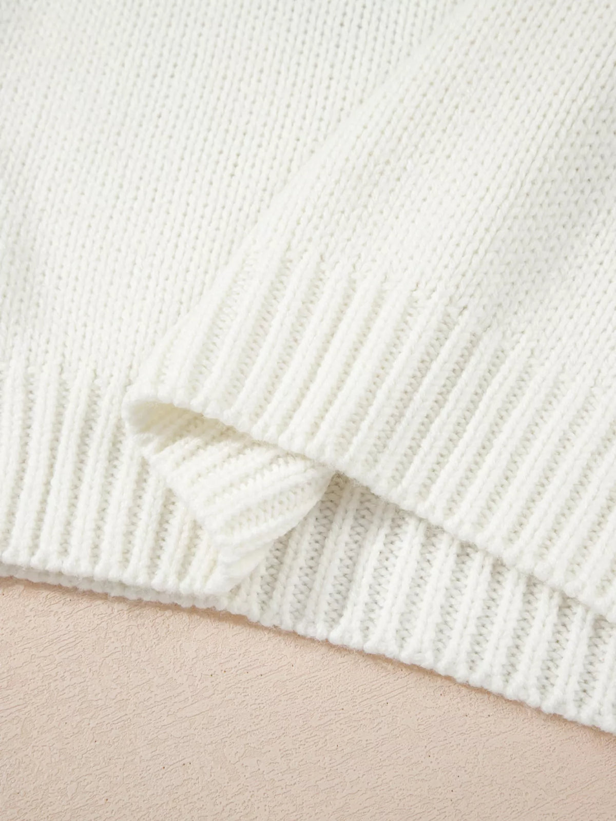 Women's Embroidered Bow Boots Drop Shoulder Sweater in cream, laid flat showing the detailed boot and bow design on the front.