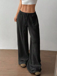 Women's plus size cotton drawstring wide leg pants in Black, showing relaxed fit and tie waist.