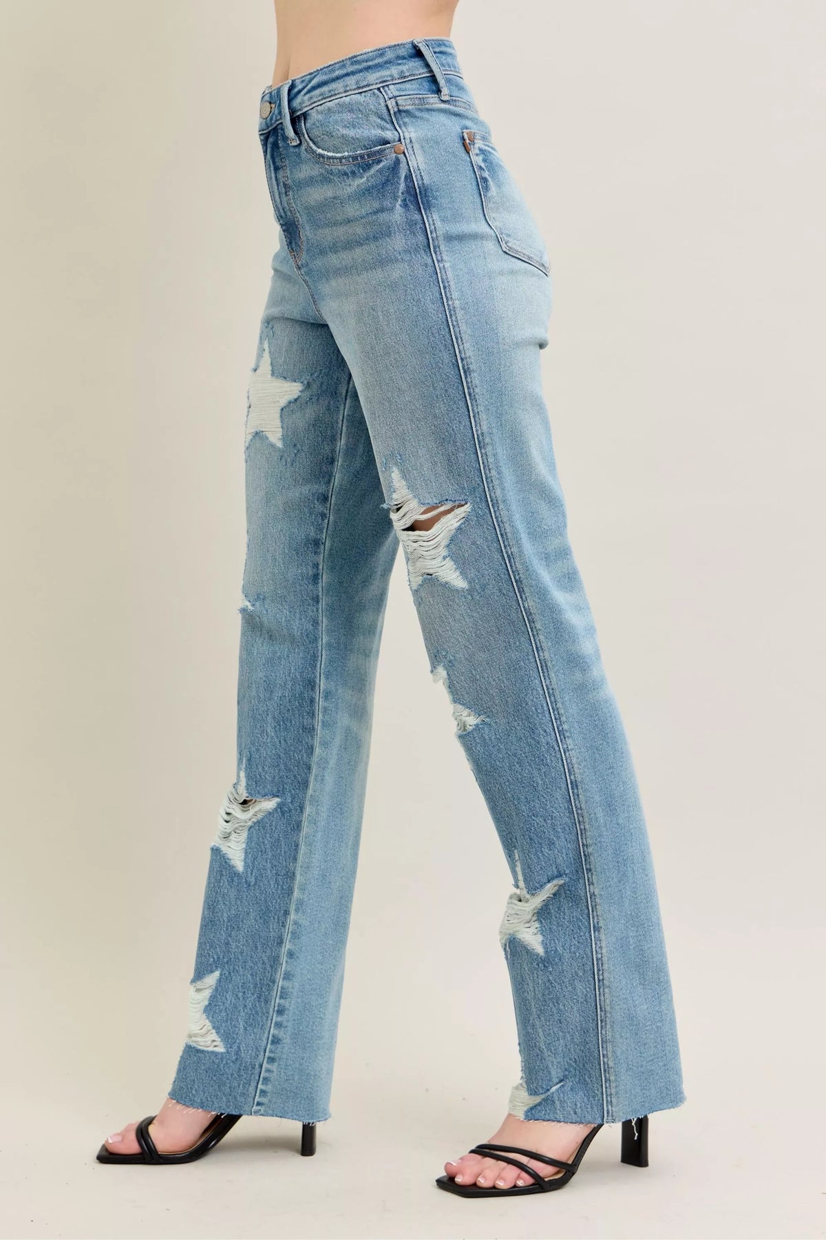 Judy Blue 90s Straight Jeans in a distressed wash, modeled from the front, showing the high waist and straight leg fit.