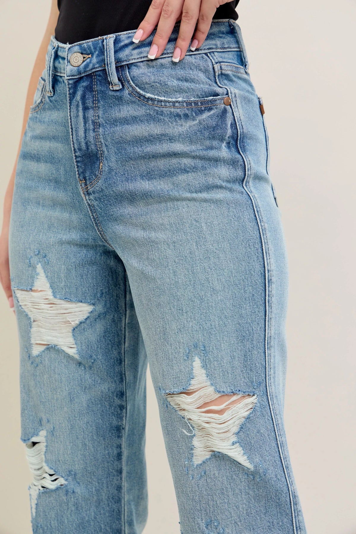Judy Blue 90s Straight Jeans in a distressed wash, modeled from the front, showing the high waist and straight leg fit.
