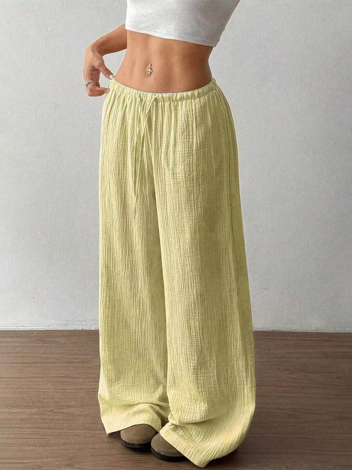 Women's plus size cotton drawstring wide leg pants, showing relaxed fit and tie waist.