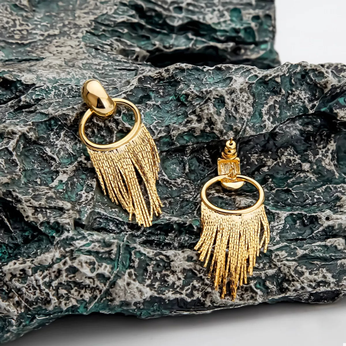 18K Gold Plated Fringe Chain Earrings dangling from a model's ear, showcasing the elegant gold finish and dynamic movement.