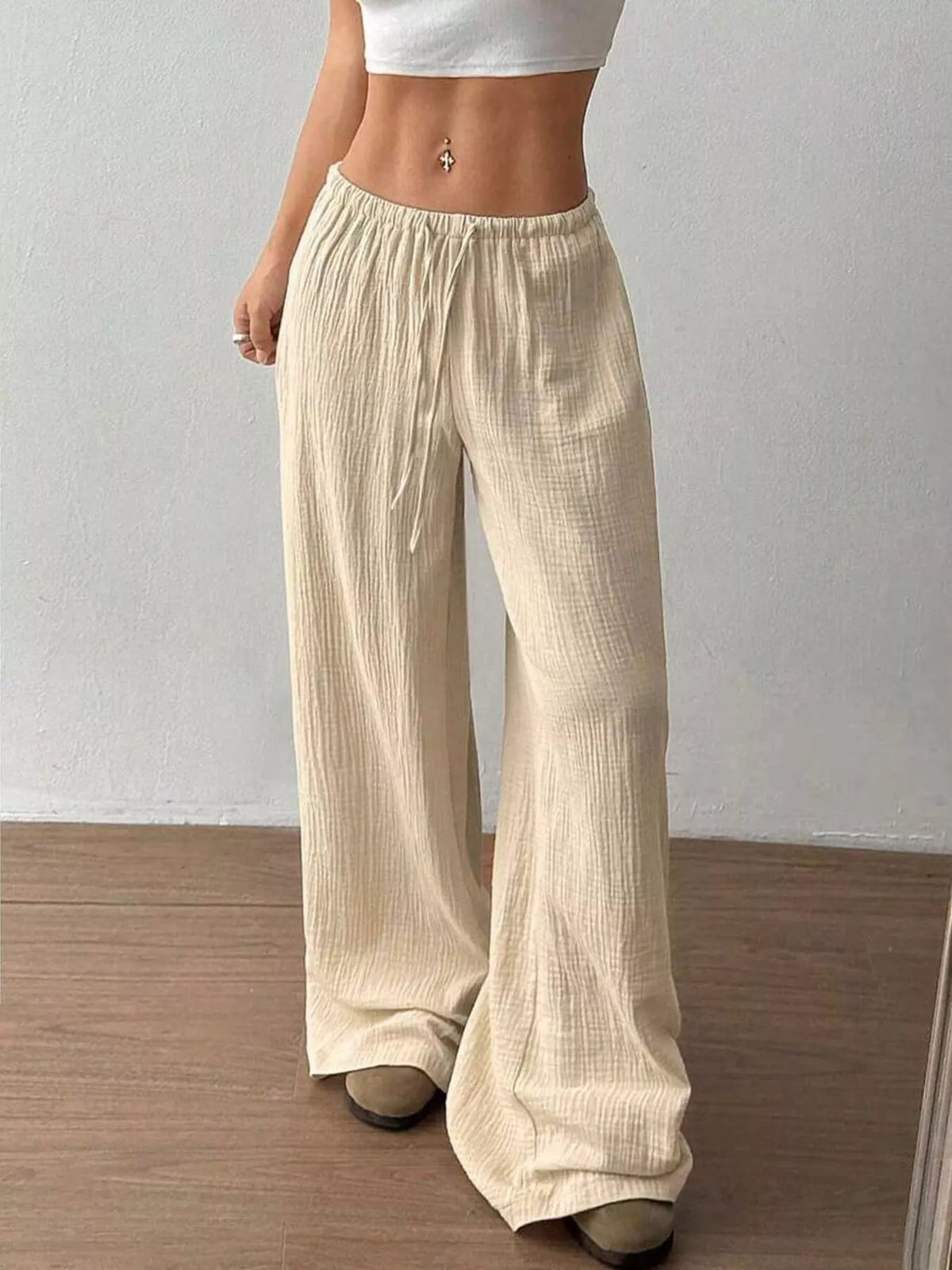 Women's plus size cotton drawstring wide leg pants, showing relaxed fit and tie waist.