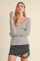 Aemi + Co women’s lettuce hem scoop neck long sleeve knit top in beige, styled with jeans for casual fall outfit
