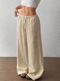 Women's plus size cotton drawstring wide leg pants, showing relaxed fit and tie waist.