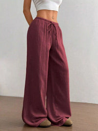 Women's plus size cotton drawstring wide leg pants in Wine Red, showing relaxed fit and tie waist.