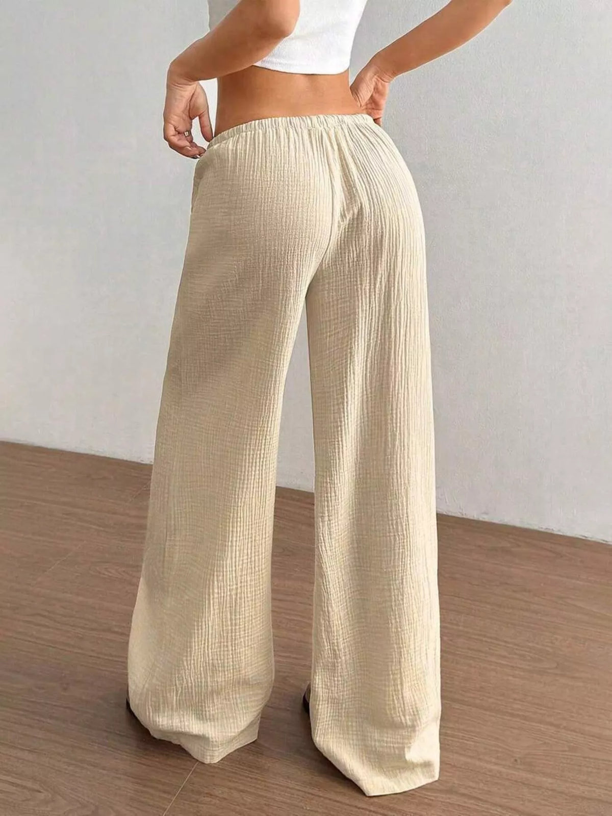 Women's plus size cotton drawstring wide leg pants, showing relaxed fit and tie waist.