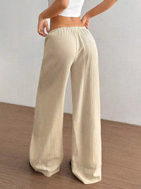 Women's plus size cotton drawstring wide leg pants, showing relaxed fit and tie waist.