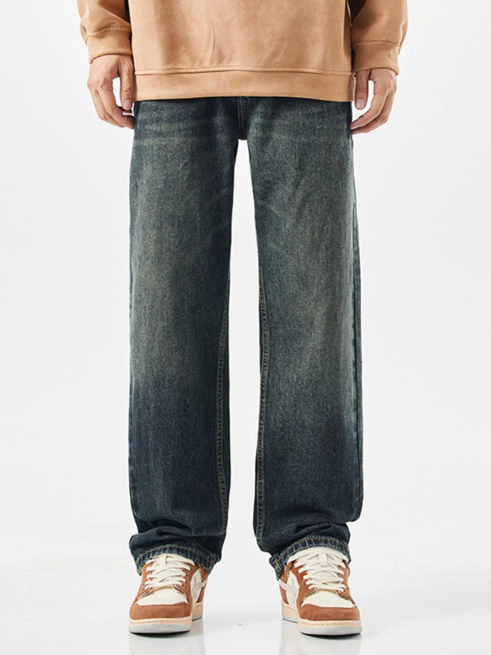 Men's relaxed fit wide leg jeans in vintage blue wash, front view.