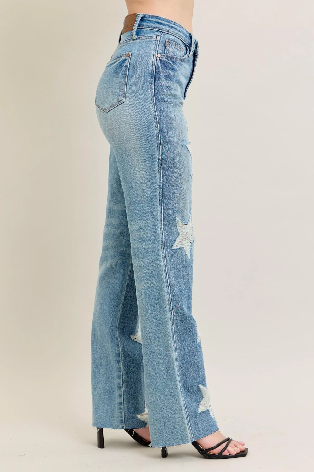 Judy Blue 90s Straight Jeans in a distressed wash, modeled from the front, showing the high waist and straight leg fit.