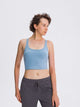 Athletic woman wearing a breathable workout tank top during yoga session