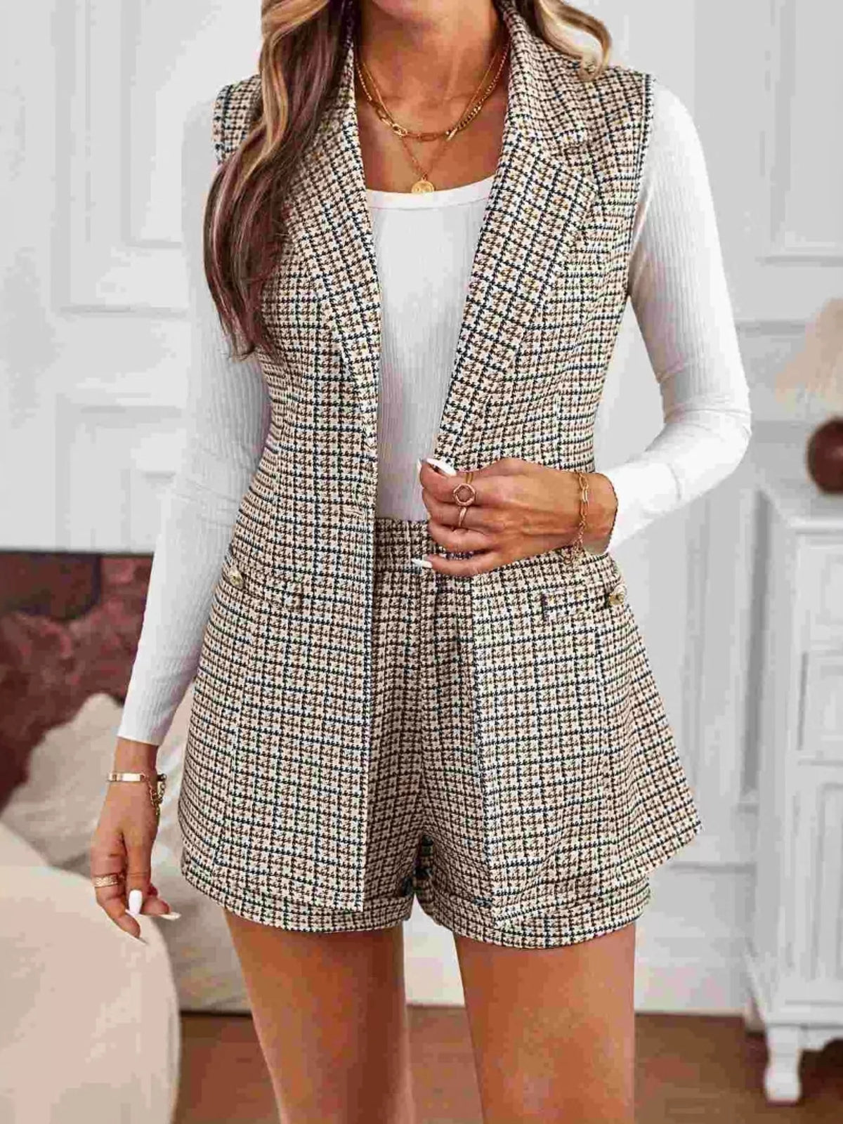 Model wearing belted houndstooth blazer vest and shorts set