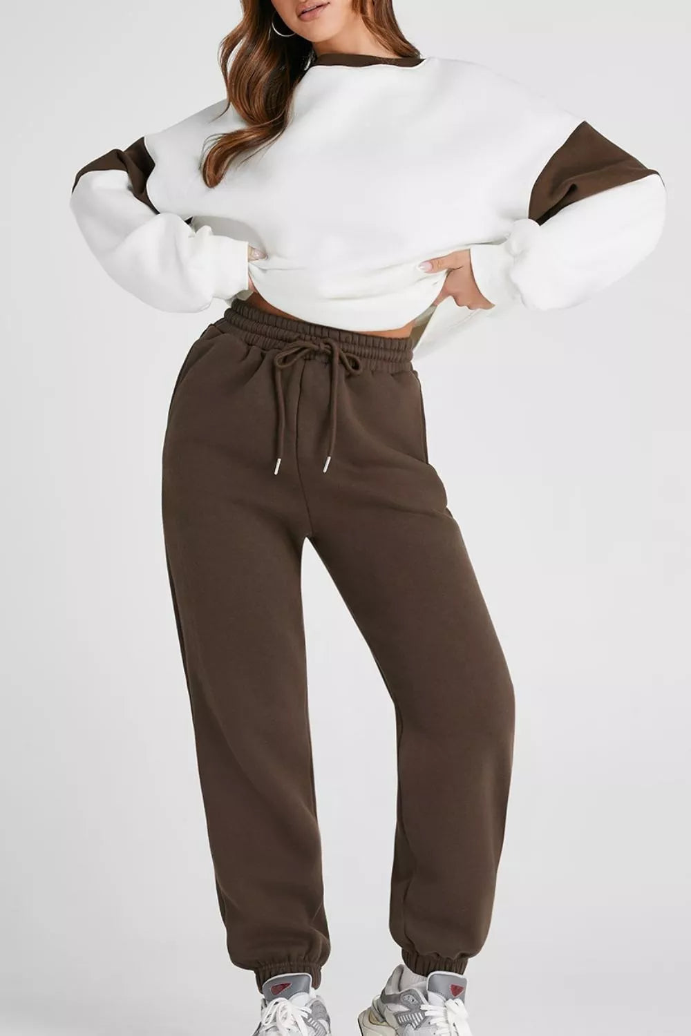 Women's Oversized Loungewear Set in White, featuring a drop-shoulder sweatshirt and matching joggers on a model.