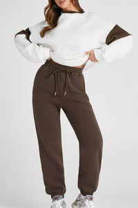 Women's Oversized Loungewear Set in White, featuring a drop-shoulder sweatshirt and matching joggers on a model.