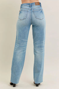 Judy Blue 90s Straight Jeans in a distressed wash, modeled from the front, showing the high waist and straight leg fit.