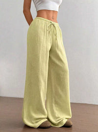 Women's plus size cotton drawstring wide leg pants, showing relaxed fit and tie waist.